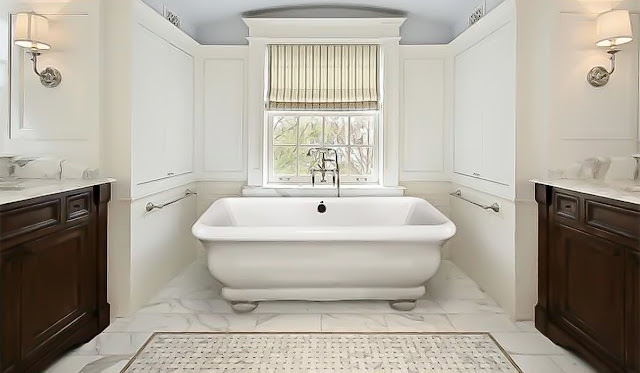 Rectangular tiered freestanding tub in a bathroom with natural wood and white tile.