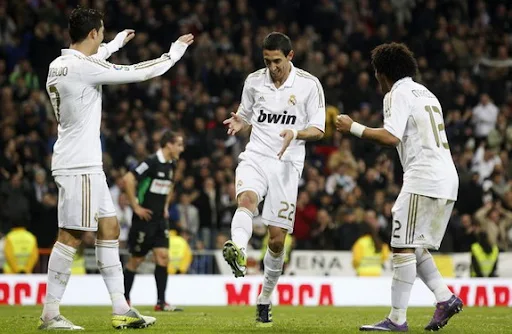 Ángel di María celebrates a goal against Racing Santander with his Real Madrid team-mates