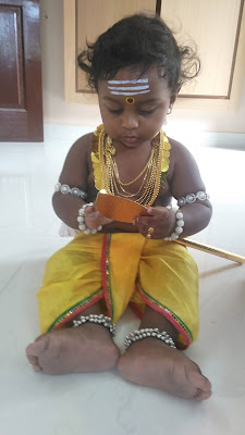 Muruga playing with his divine Vel