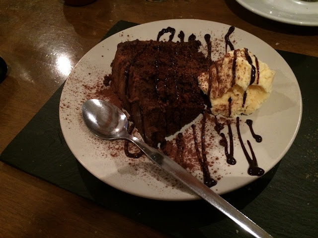 chocolate fudge cake with vanilla ice cream and long silver spoon