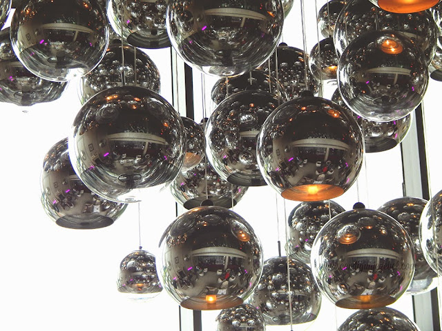 Silver spheres with lights hanging at different lengths in the G hotel Galway