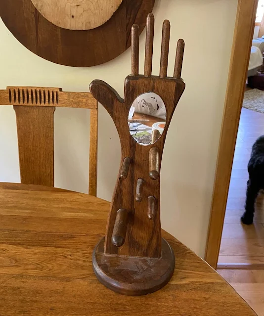 Photo of a dark wooden hand shaped jewelry holder