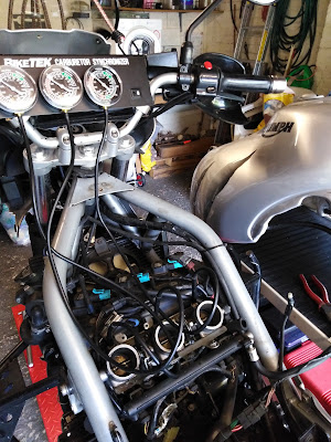 Throttle bodies being balanced with fuel tank resting on cabinet to the side