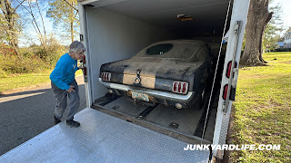 Mary Ann Vann moves behind the Mustang after loading onto enclosed trailer.