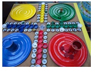 http://manualidadesparaninos.biz/juego-de-parchis-con-materiales-reciclables/