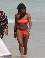 Bikini candids Alexandra Burke wear a tiny orange two-piece in picture gallery