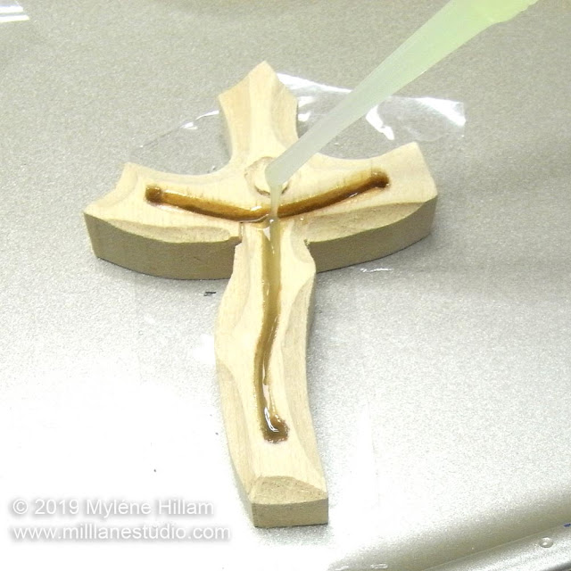 Transferring the resin from the pipette into the slot on the crucifix.