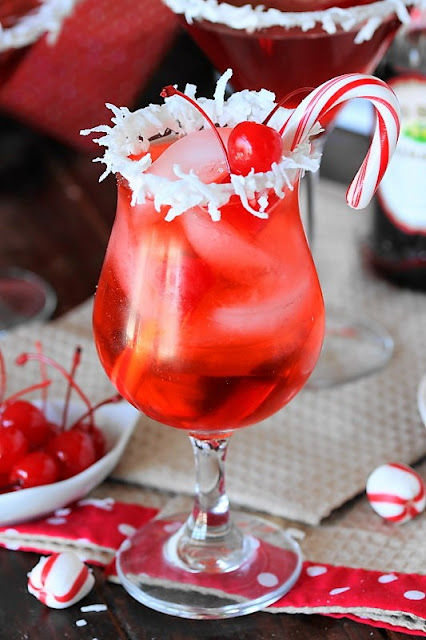 Santa's Hat Shirley Temple image ~ Let the kids in on the Christmas drink fun with this festive Santa's Hat Shirley Temple!  With it's bright red color and coconut rim, it'll be the hit of the holiday season with the little ones.