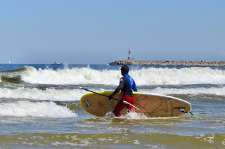 SUPsurfer going through whitewater