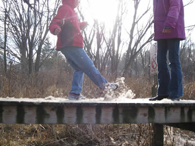 Joy and Rose kick "snow" on a pier (cattail fluff)