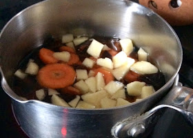 saucepan with ingredience for homemade sugar substitute for baking: carrot, apricot and apple
