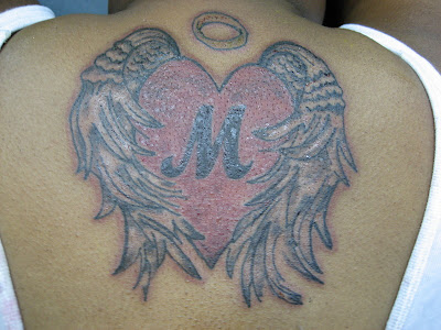 Female Spine Tattoo of Hearts · Back Tattoo on Spine of Girl