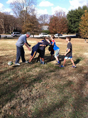 Terry shows the boys how a scrum works.