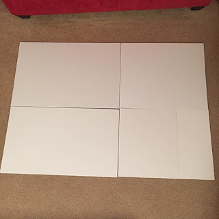 White foam core boards cut down to size to fit the back of a large puzzle