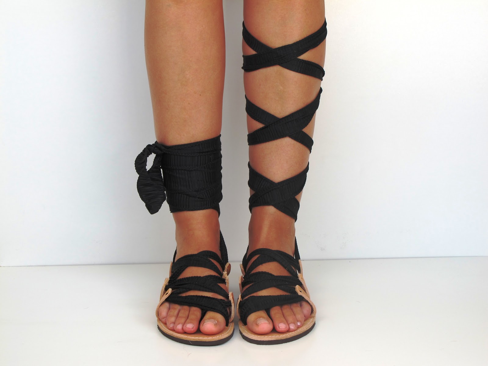 Beige sandals with plisse jersey straps in black.