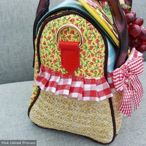 side of handbag in wicker, floral and gingham trim