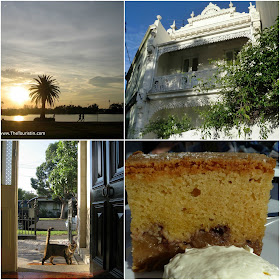 Sunset over a lake. The facade of a white Victorian house. A tiger cat looking through the front door of a Victorian house. Apple cake served with cream.