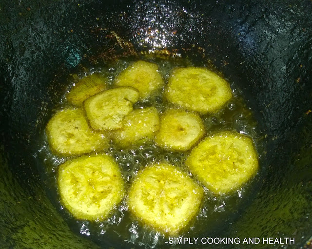Plantain chips frying in a small wok