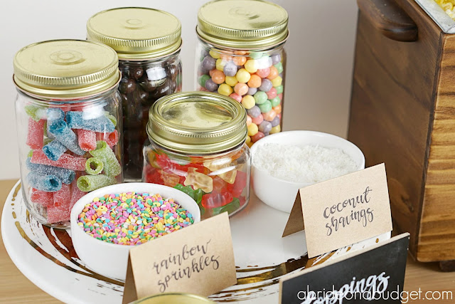 Thinking of a popcorn bar for your wedding? Figure out exactly what you need to do in this DIY Wedding Popcorn Bar post on www.abrideonabudget.com. #wedding #weddingplanning #actionstation #popcornbar #diywedding