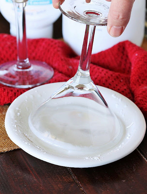 Dipping Martini Glass Rim in Powdered Sugar + Water to Moisten Image