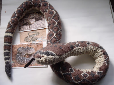 an images of rattlesnakes with a knitted rattlesnake around it.