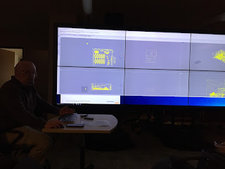 Photo of AVL team member Jeff and part of the IQ-Wall at the lab at IUPUI. This IQ-Wall consists of 2 rows of 4 displays all working together as a single large display.