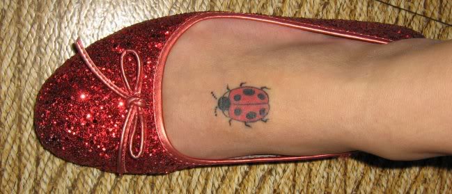 ladybug tattoo on top of foot.