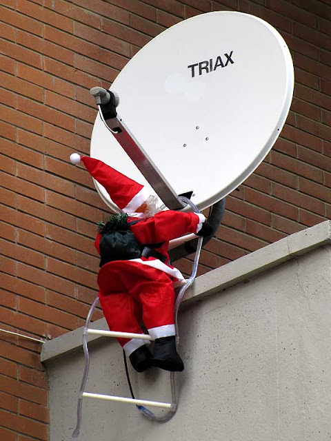 Santa fixing a dish antenna, Livorno