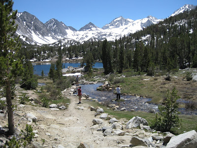 three boys stand by babbling brook in High Sierra