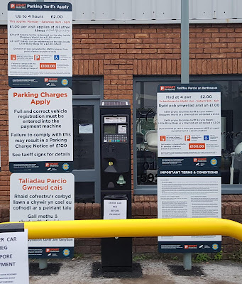 wall of signs, each with 0845 number and no access charges shown in breach of Ofcom regulations