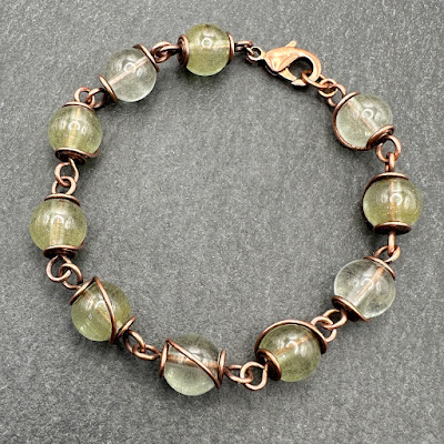 Handmade lampwork glass and copper wirework bracelet by Laura Sparling