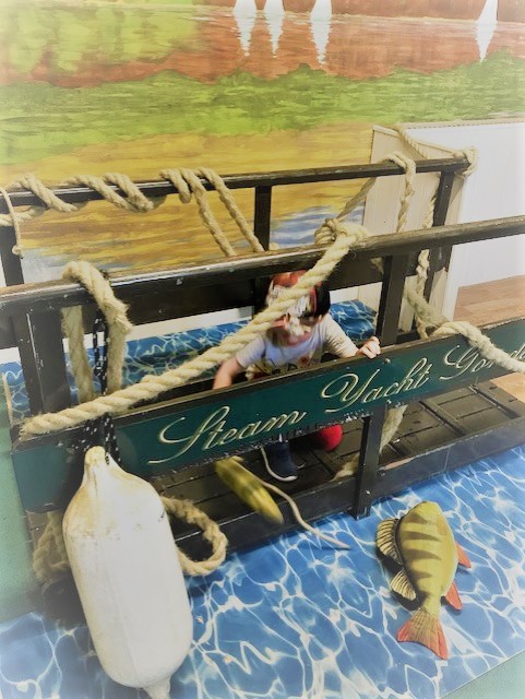 Child sitting on a mock bridge