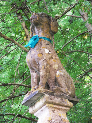 Dog statue in Tawstock Devon with ribbons