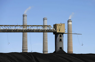 Coal piles sit outside a PacifiCorp power plant near Castle Dale, Utah. The plan rejected by regulators would have paid utilities extra to keep stockpiles of coal on hand. (Credit: George Frey/Getty Images) Click to Enlarge.