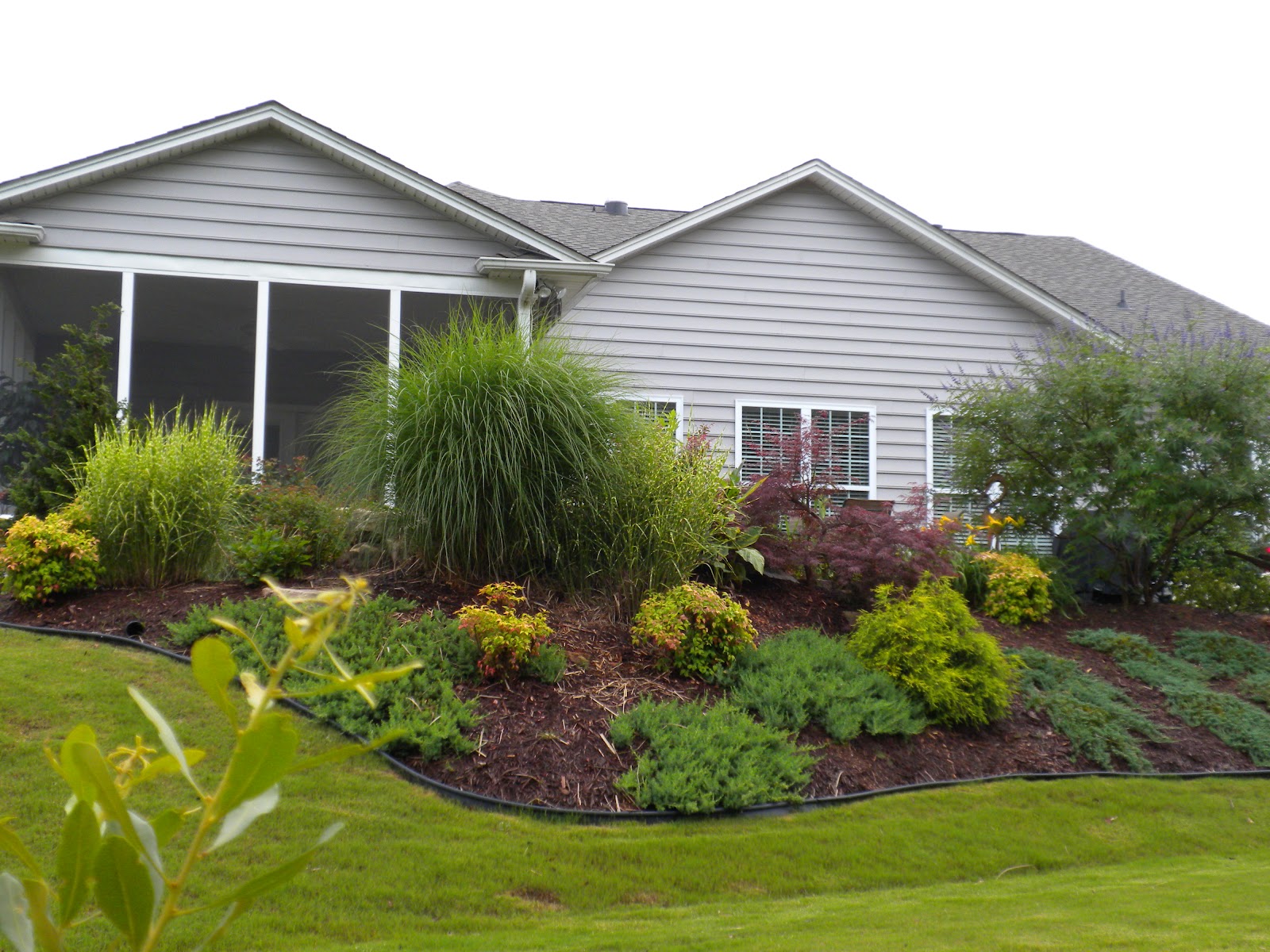 Isn't this a beautifully landscaped sloping back yard. They have  title=