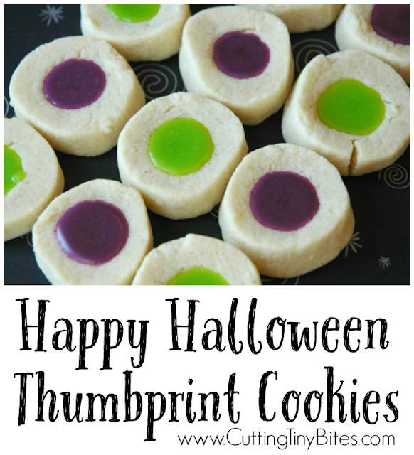 Happy Halloween Thumbprint Cookies. Delicious little sweet bite with fun Halloween colors! Buttery shortbread cookie with drizzle of sweet frosting. Great for a kids party or snack!