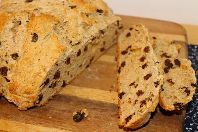 Sliced loaf of Irish Soda Bread with whiskey raisins and caraway.