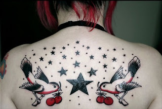 star and bird tattoo on girl's back body