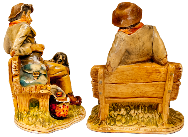 Two back views of the old tramp figurine on his bench.