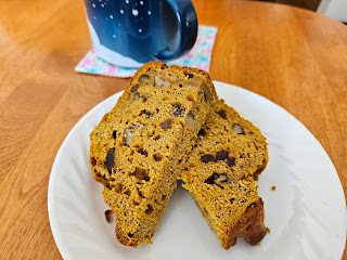 Sliced Pumpkin bread on plate with tea cup.