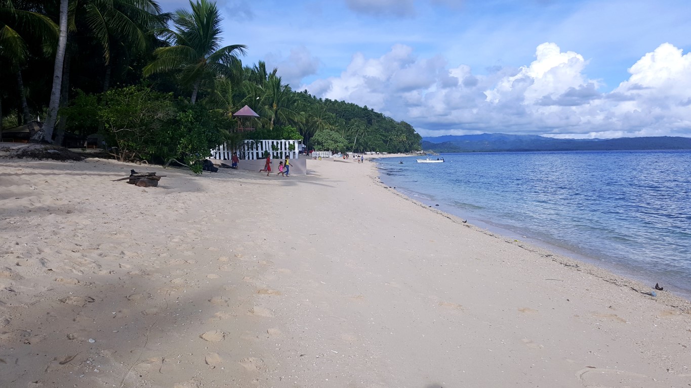 a long stretch of white sand beach at Isla Jardin Del Mar Resort in Glan, Sarangani