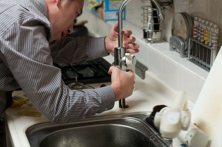 workman fixing taps