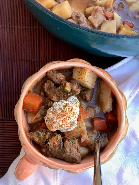 Bowl of German Goulash Soup topped with sour cream.