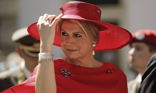 Queen Maxima wore a new Jamba half-long draped silk crepe red dress by Natan. Diamond and pearl drop brooch