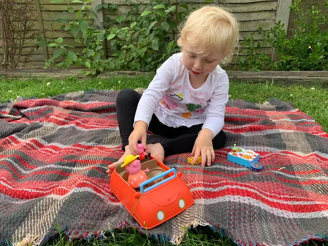 putting peppa pig in her toy car