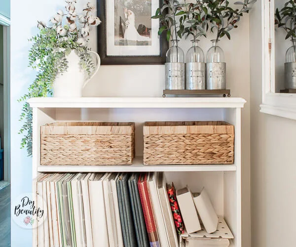 white bookcase with fabric covered albums