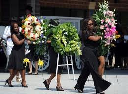 Women carry flowers