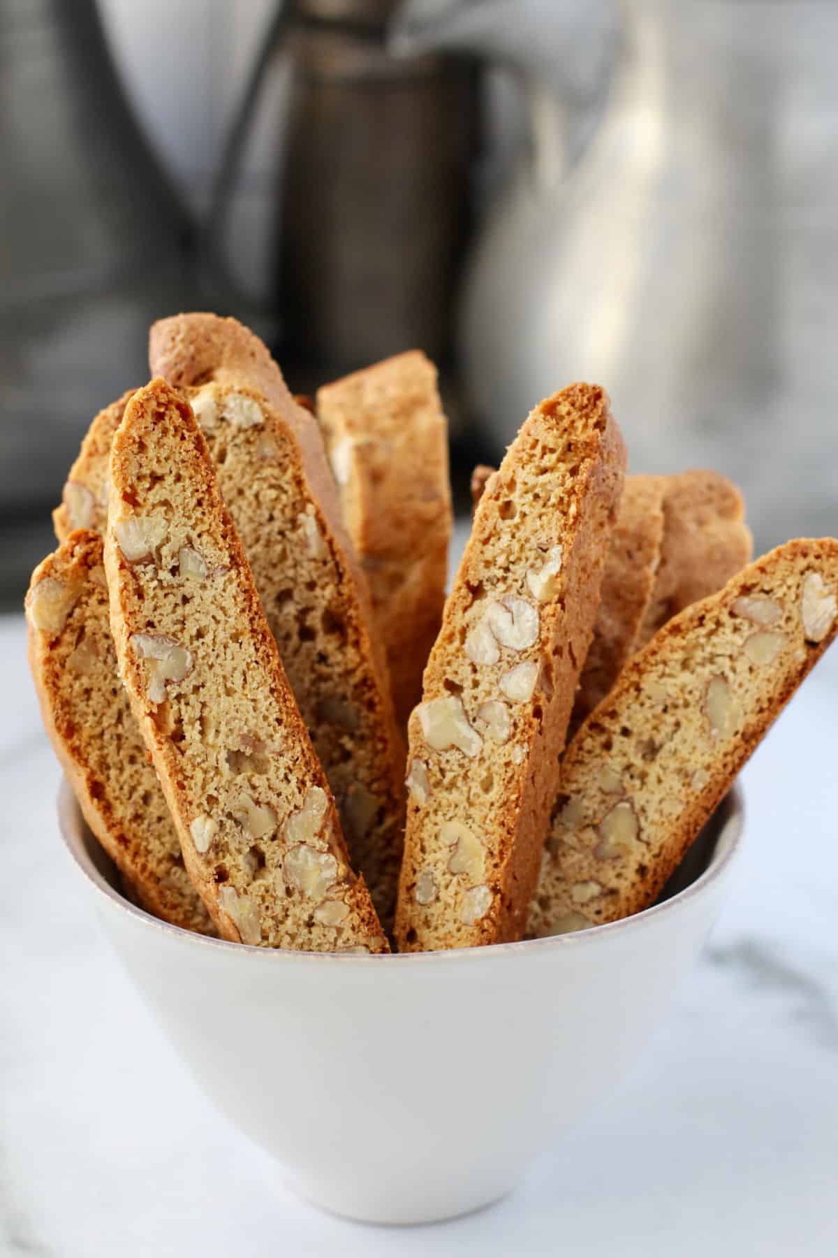 Maple Pecan Biscotti standing up in a white bowl.