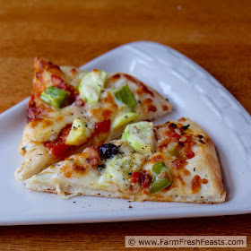 This pizza is a vegetarian's Late Summer Dream. Squash, peppers, olives and slow-roasted tomatoes covered with cheese.