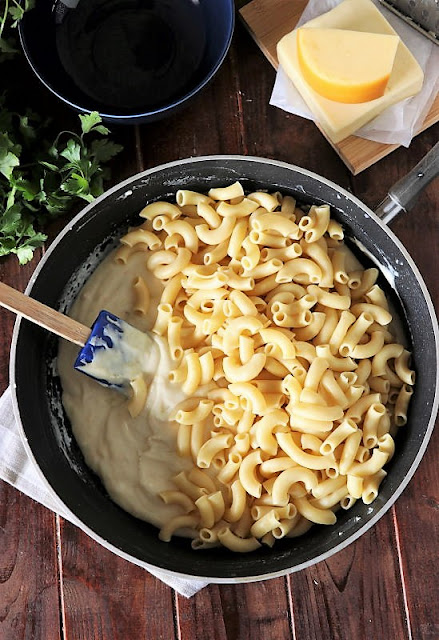 Adding Macaroni to Cheese Sauce Image